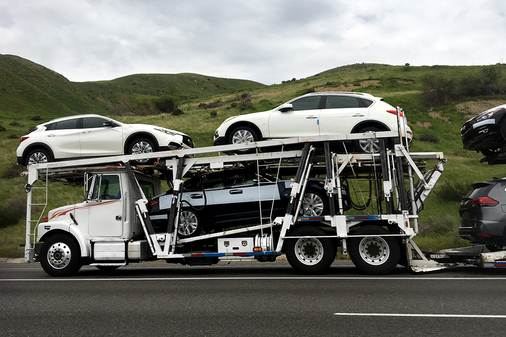 cars being shipped on an open trailer in Albuquerque New Mexico